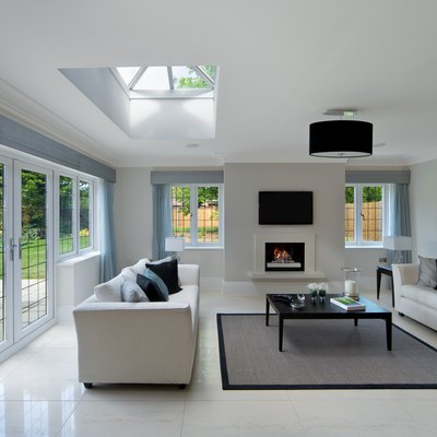 Bright living room with skylight and tiled floor.