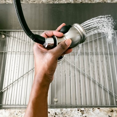 Woman Rinses Kitchen Sink