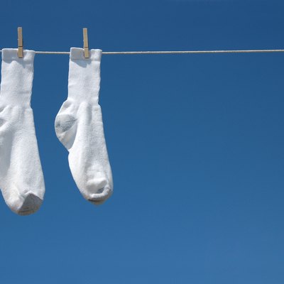 White socks hanging on clothesline.
