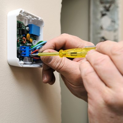 Installing a programmable room thermostat.