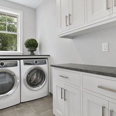 White laundry room with new appliances