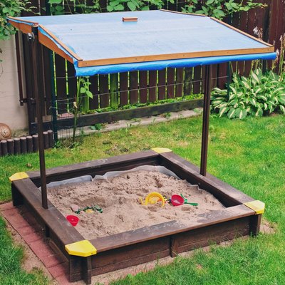 Kids Sandbox with Blue Canopy Roof Built in Backyard Garden