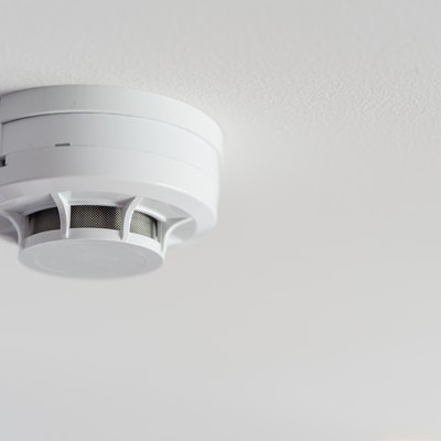 Close up smoke detector on a ceiling.