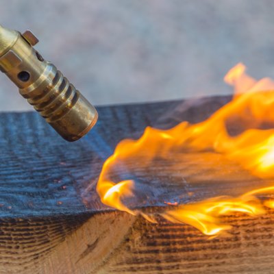 fire from a gas burner treated lumber