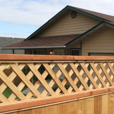 Wooden privacy fence with diagonal trellis detail