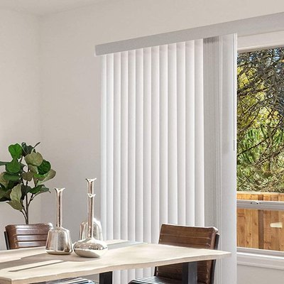 Modern white dining room with vertical blinds and houseplant.
