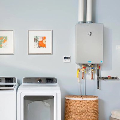 A tankless water heater is installed in a colorful laundry room