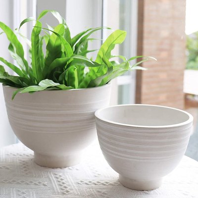 Indoor-outdoor decorative planter pots.