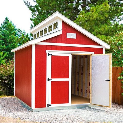 A modern, red Tuff Shed on a gravel patio