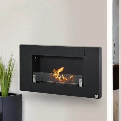 A black ethanol fireplace with a flame going against a cream interior wall