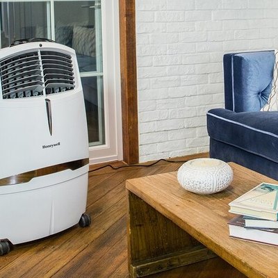 Portable indoor evaporative cooler in blue and white living room