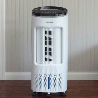 Portable black and white evaporative cooler in room with pale gray wall, white woodwork, dark wood or laminate flooring