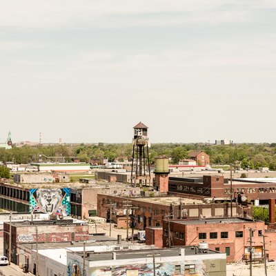 Distance view of city with industrial brick buildings and water tower