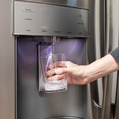 Water from refrigerator filter system filling glass