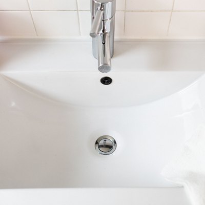 closeup of white sink with silver single-handle faucet