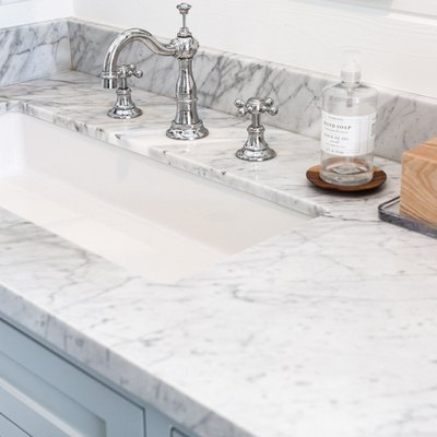 Marble countertop, white undermount sink, silver faucet and handles