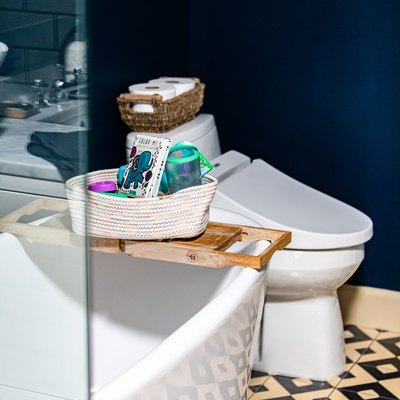 White-black geometric bathroom floor with a white bathtub and toilet