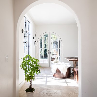 An arch doorway with a plant in a Mediterranean styled home