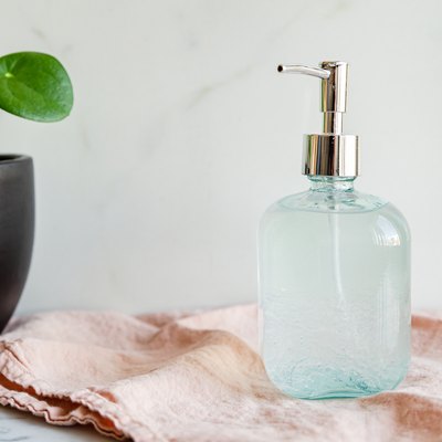 a glass jar with a pump full of diy hand sanitizer