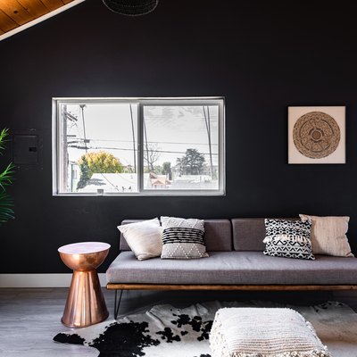 Living room color idea with black-white walls, wood ceiling, gray wood floors, gray-neutral furnishings
