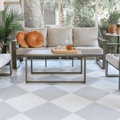 Gray and white checkerboard floor of a sunroom with gray and white furniture