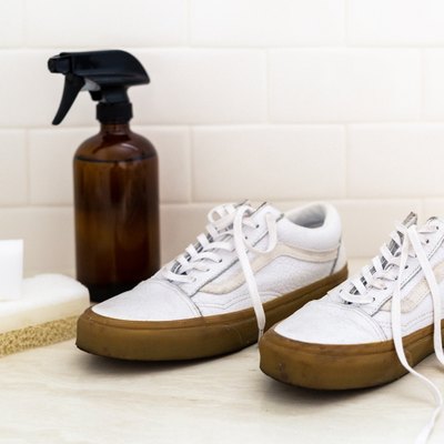 Countertop with sneakers, spray bottle, and sponge