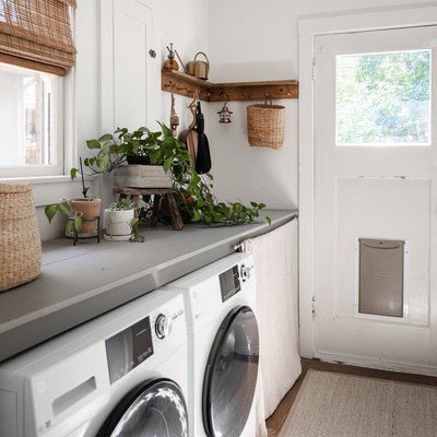 Laundry room with plants, neutral and gray accents.