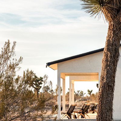 Ranch style house with outdoor seating, situated in the desert