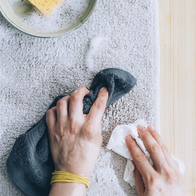using a cloth towel to blot soapy residue