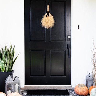 black exterior door with autumn decor