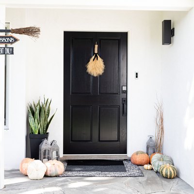 black exterior door with fall decor