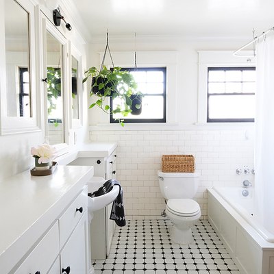 White walled bathroom with white-black tiled floor