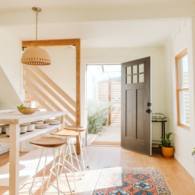 pendant lamp and wooden bar stools with wooden kitchen island in kitchen