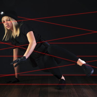 Cat burglar negotiating laser beam alarm system