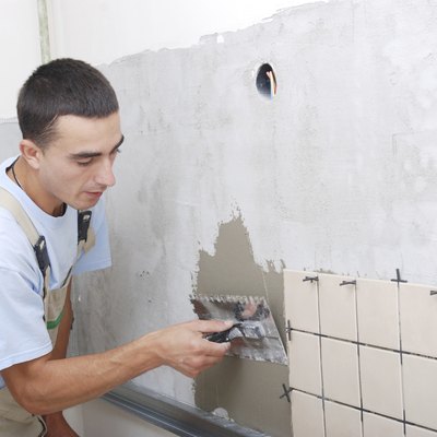 Hands on trowel spreading mortar