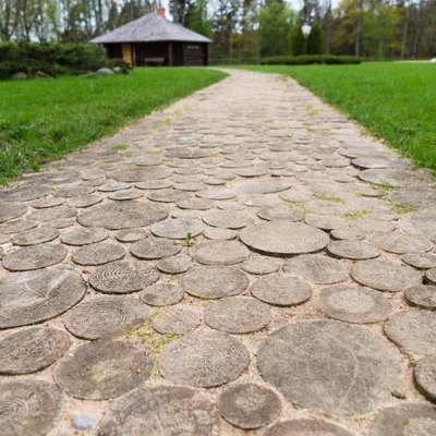 Wooden round log path closeup in summer recreation camping site