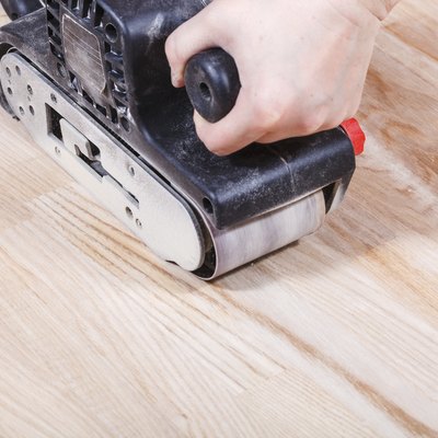 finishing wooden surface by hand-held belt sander