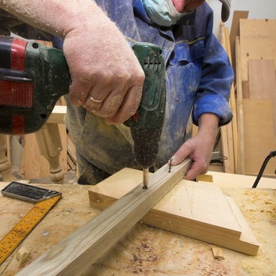 working carpenter with drill.