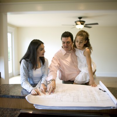 Family looking at blueprints in new home