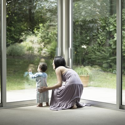 Mother and son looking out window