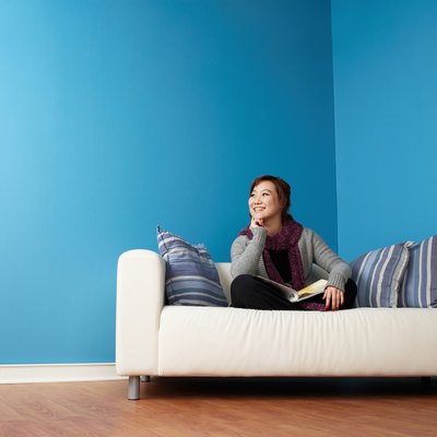 Smiling woman on sofa with book