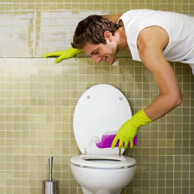 Man cleaning toilet