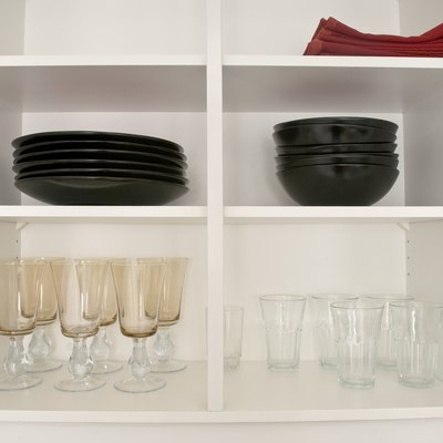 Open kitchen cabinets with dishes and glasses