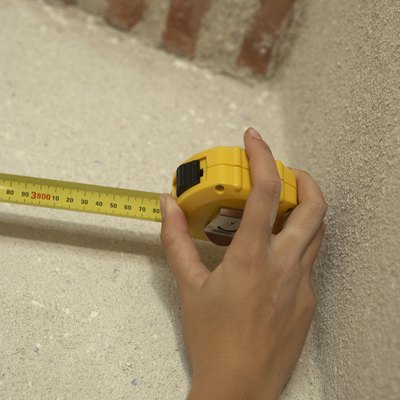 Hand using tape measure