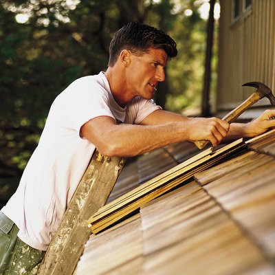 Man installing roof shingles