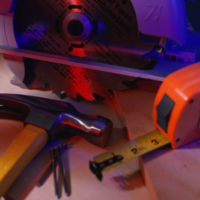 Tape measure, hammer, nails and round table saw