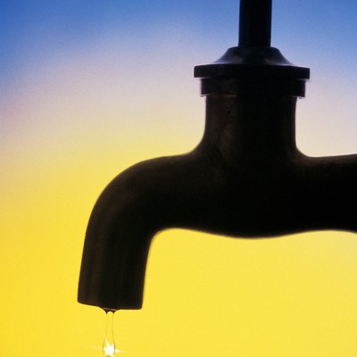 Dripping faucet in silhouette