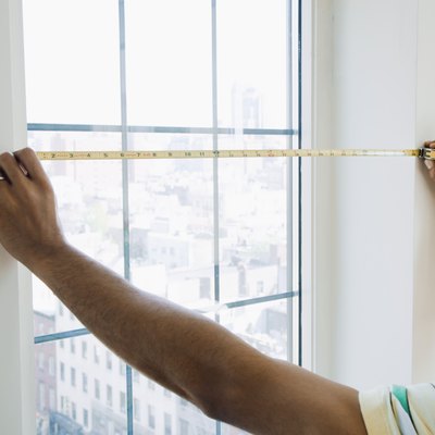 Man measuring window size