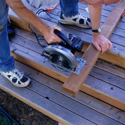 Carpenter Sawing Boards