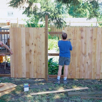 Carpenters Building a Fence